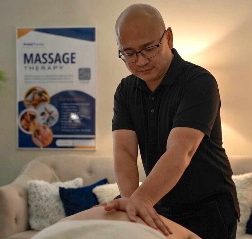 Felix Mora, LMT NMT, working with a client